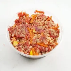 A bowl of rice and meat on top of the table.