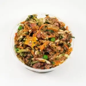 A bowl of food with rice, vegetables and meat.