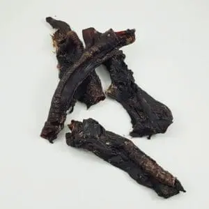 A close up of some beef jerky on a table