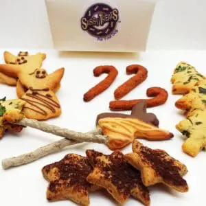 A table topped with lots of cookies and some are shaped like numbers.