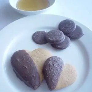 A white plate topped with cookies and chocolate.